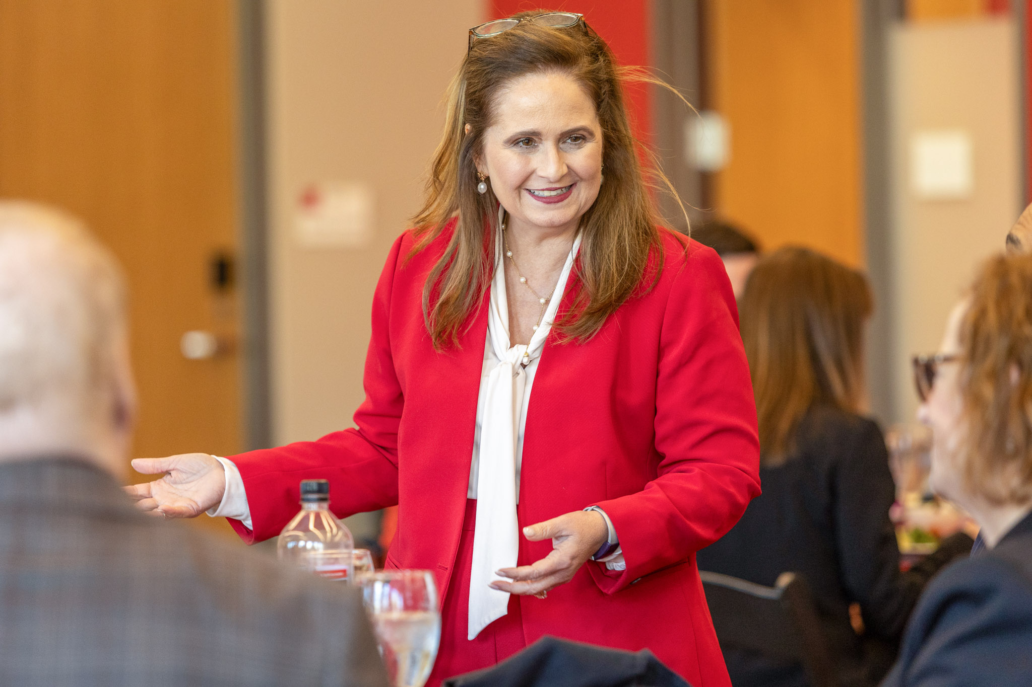 Chief Judge Jennifer Walker Elrod talks with guests during a dinner with University of Houston Law Center leadership, alumni, and friends.